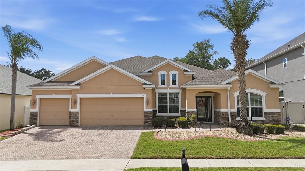 979 Counts Crest Circle Apopka, FL 32712 - Photo 1 of 48 a front view of a house with a yard and garage