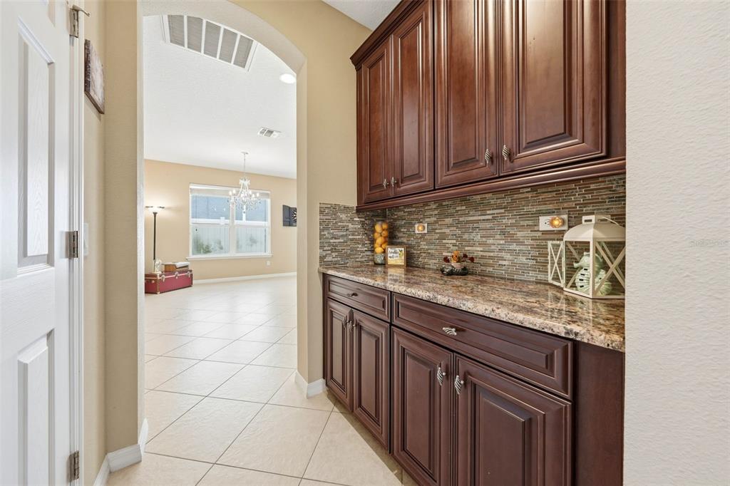 979 Counts Crest Circle Apopka, FL 32712 - Photo 11 of 48 a kitchen with stainless steel appliances granite countertop a sink and cabinets with wooden floor