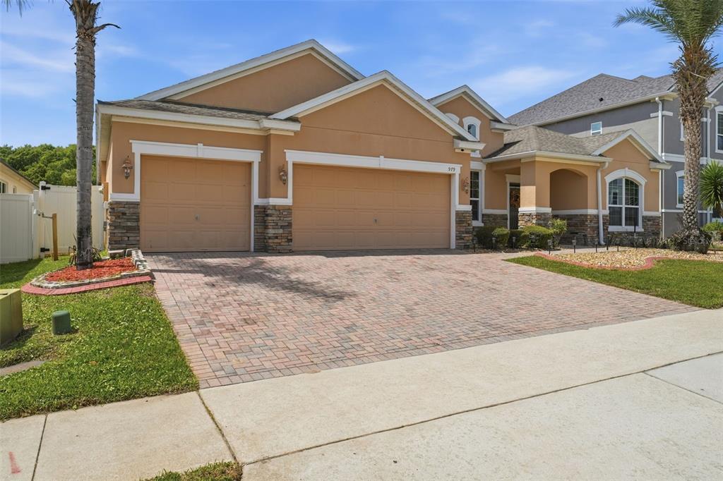 979 Counts Crest Circle Apopka, FL 32712 - Photo 3 of 48 a front view of a house with a yard and garage