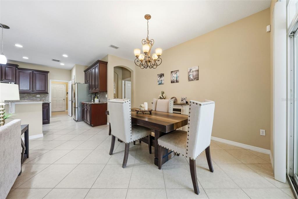 979 Counts Crest Circle Apopka, FL 32712 - Photo 42 of 48 a view of a dining room with furniture and a chandelier
