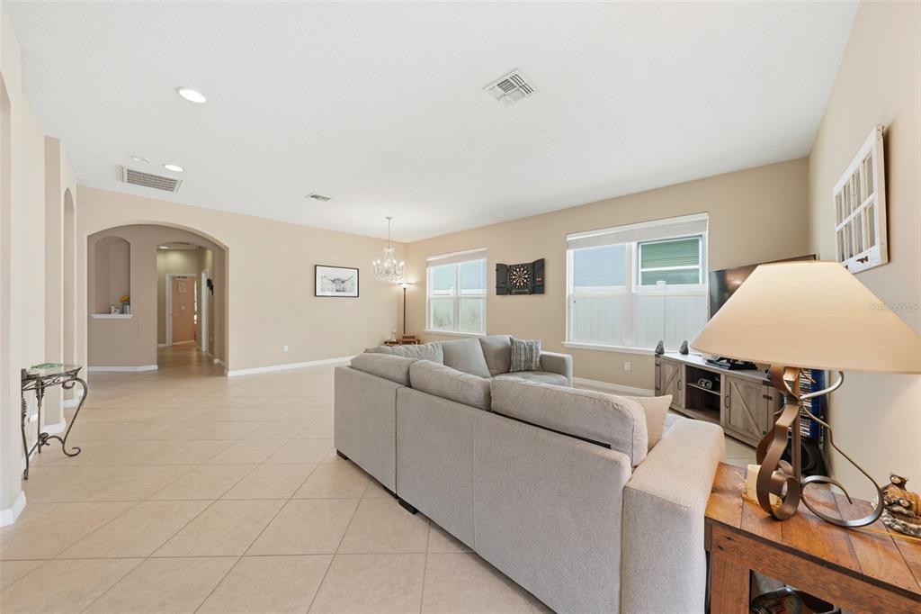 979 Counts Crest Circle Apopka, FL 32712 - Photo 43 of 48 a living room with furniture a flat screen tv and gym equipment