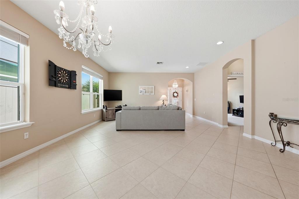 979 Counts Crest Circle Apopka, FL 32712 - Photo 9 of 48 a living room with furniture and a chandelier