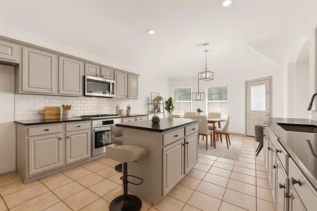 a kitchen with stainless steel appliances a stove sink cabinets and a counter top space