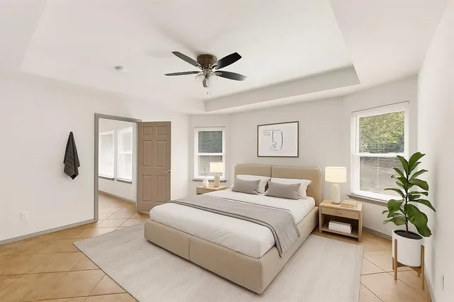 a bedroom with a bed and a potted plant