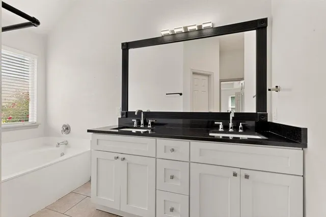 a bathroom with a sink and a mirror white cabinet
