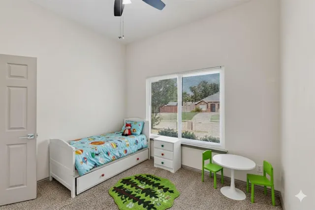 a bedroom with a bed a couch and a window