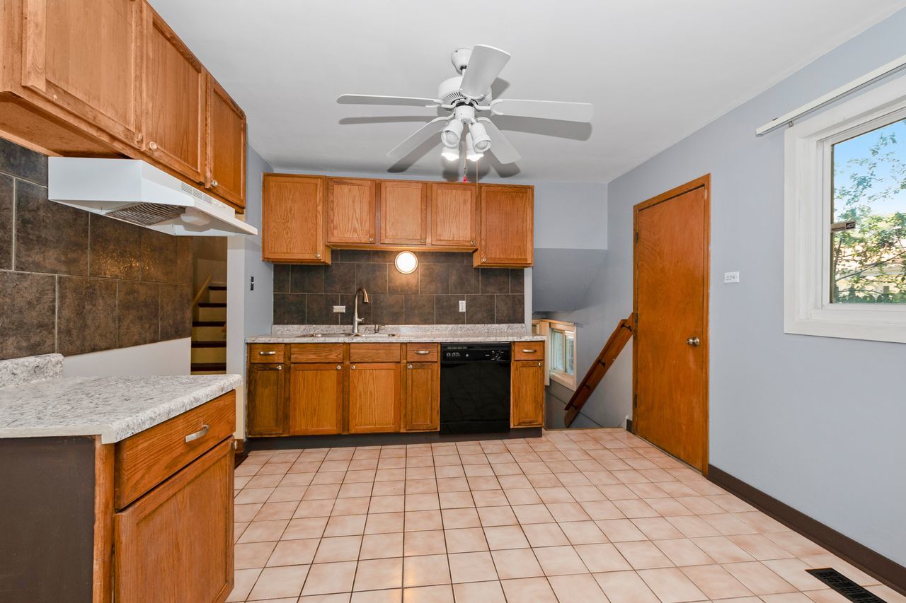 300 Indiana Street Park Forest, IL 60466 - Photo 11 of 26 a kitchen with stainless steel appliances granite countertop a sink stove and cabinets