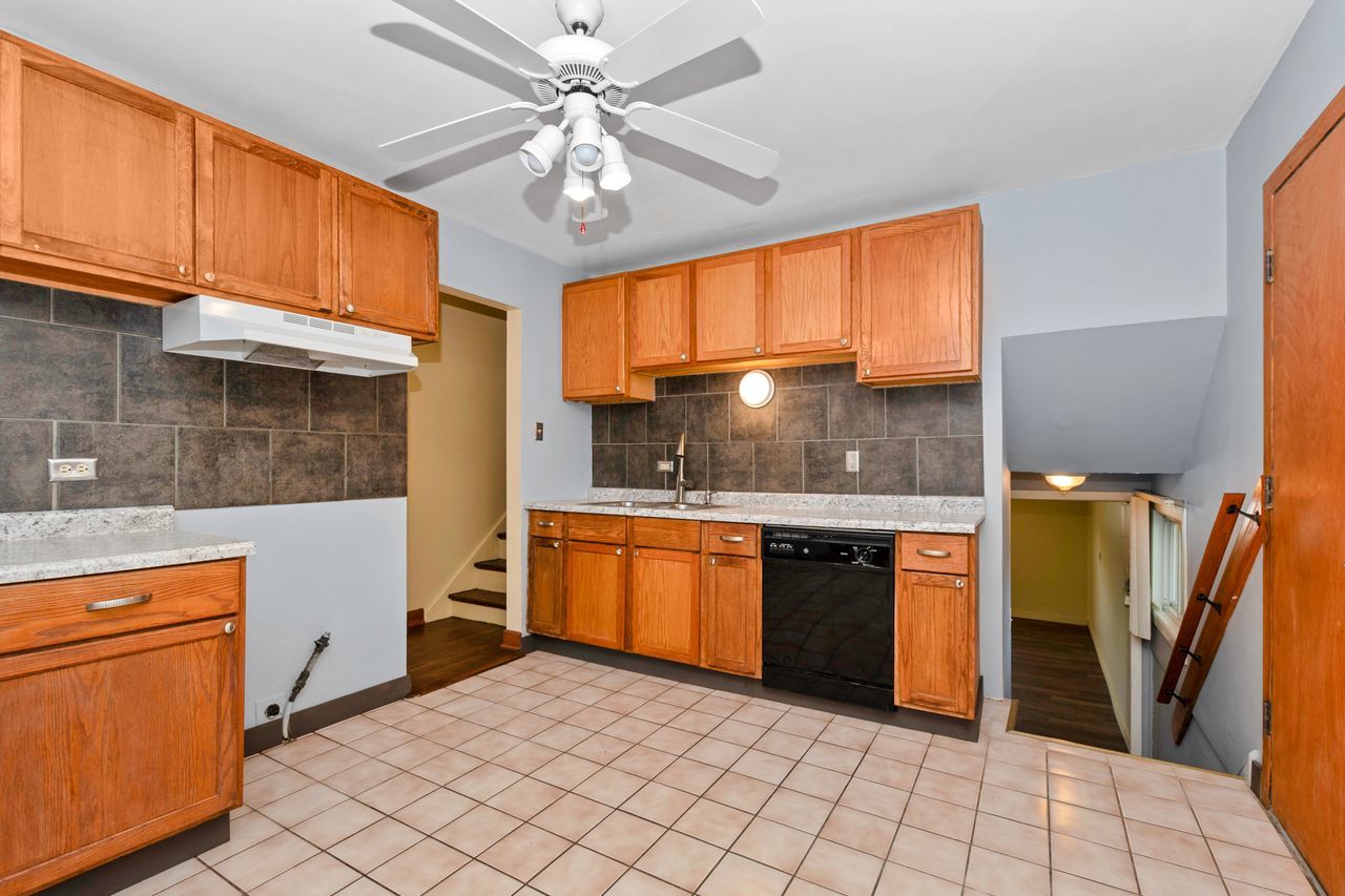 300 Indiana Street Park Forest, IL 60466 - Photo 12 of 26 a kitchen with stainless steel appliances granite countertop a stove a sink and a microwave