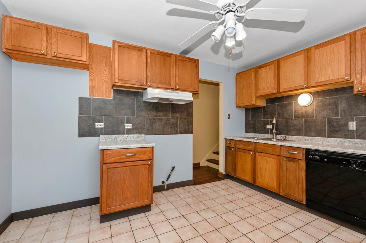 300 Indiana Street Park Forest, IL 60466 - Photo 13 of 26 a kitchen with stainless steel appliances granite countertop a sink and cabinets