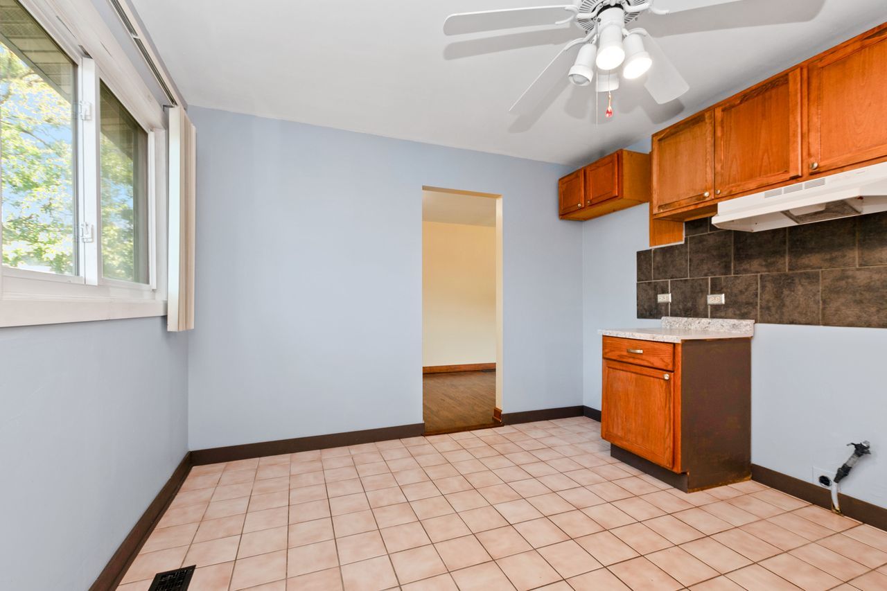 300 Indiana Street Park Forest, IL 60466 - Photo 14 of 26 a view of an empty room with window and chandelier fan