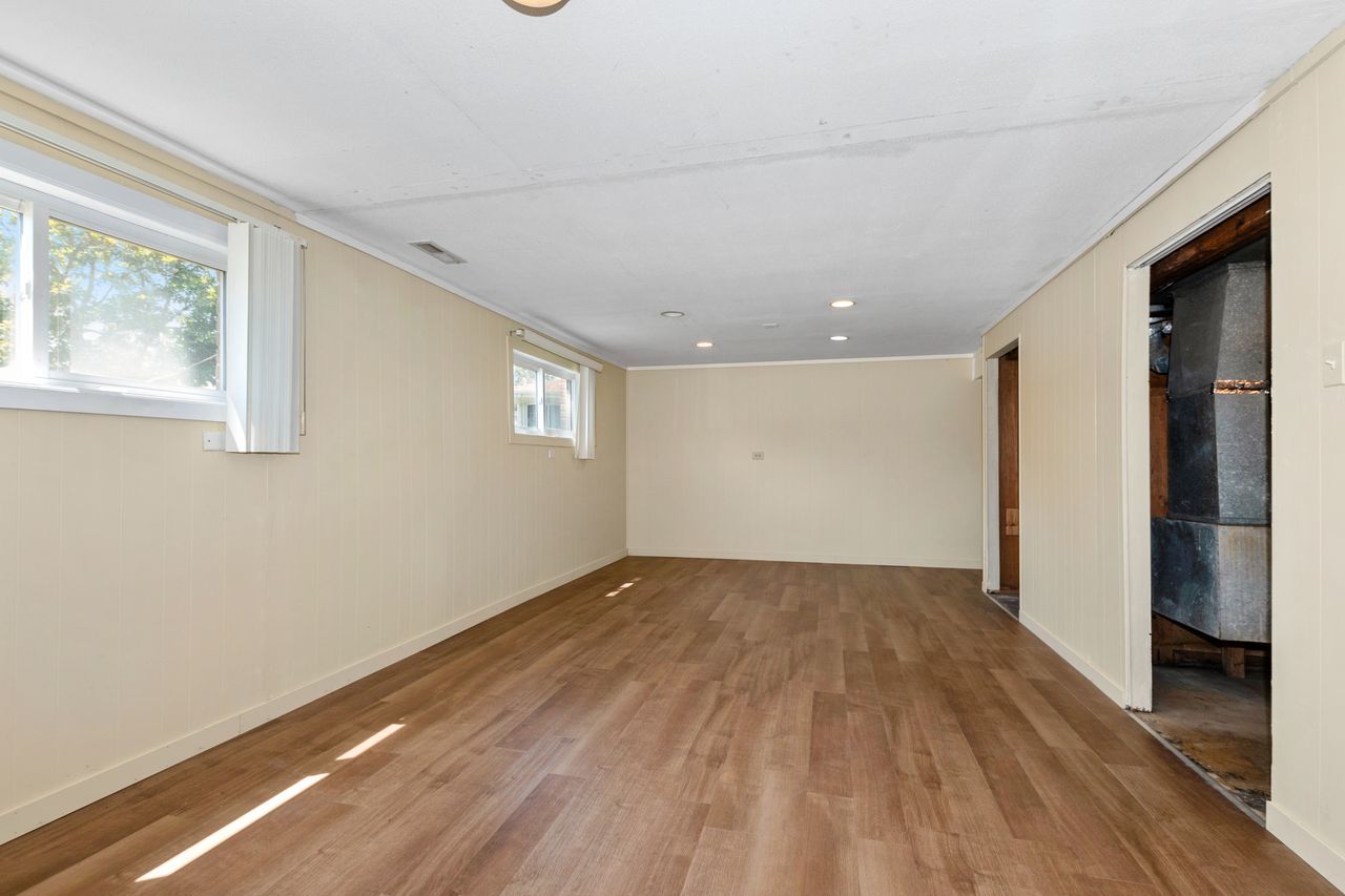 300 Indiana Street Park Forest, IL 60466 - Photo 15 of 26 a view of an empty room with wooden floor and a window