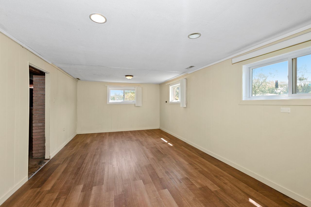 300 Indiana Street Park Forest, IL 60466 - Photo 16 of 26 a view of an empty room with wooden floor and a window
