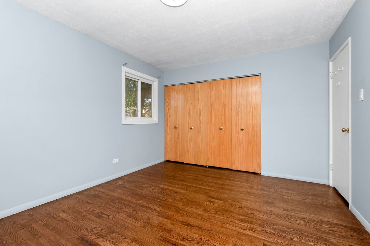 300 Indiana Street Park Forest, IL 60466 - Photo 18 of 26 an empty room with wooden floor and windows