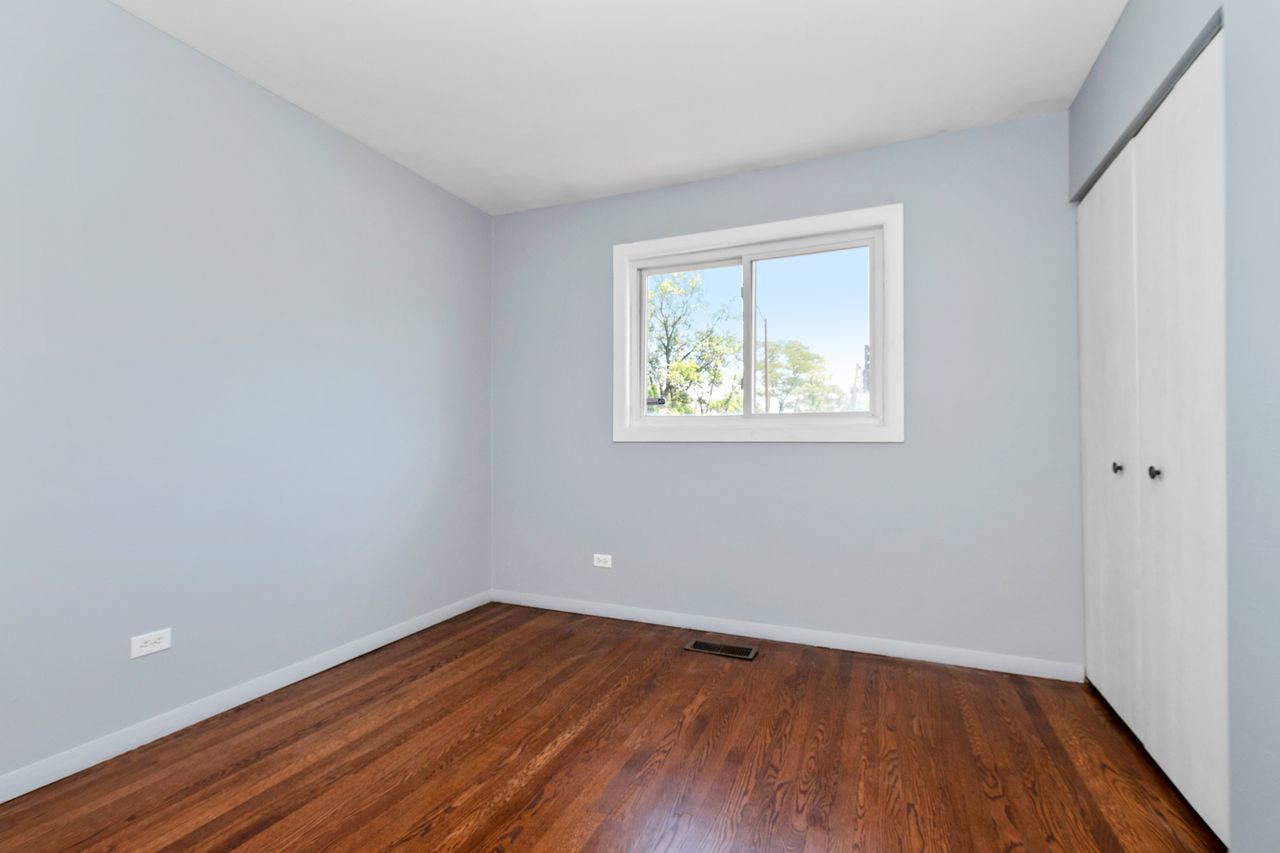 300 Indiana Street Park Forest, IL 60466 - Photo 19 of 26 a view of an empty room with wooden floor and a window