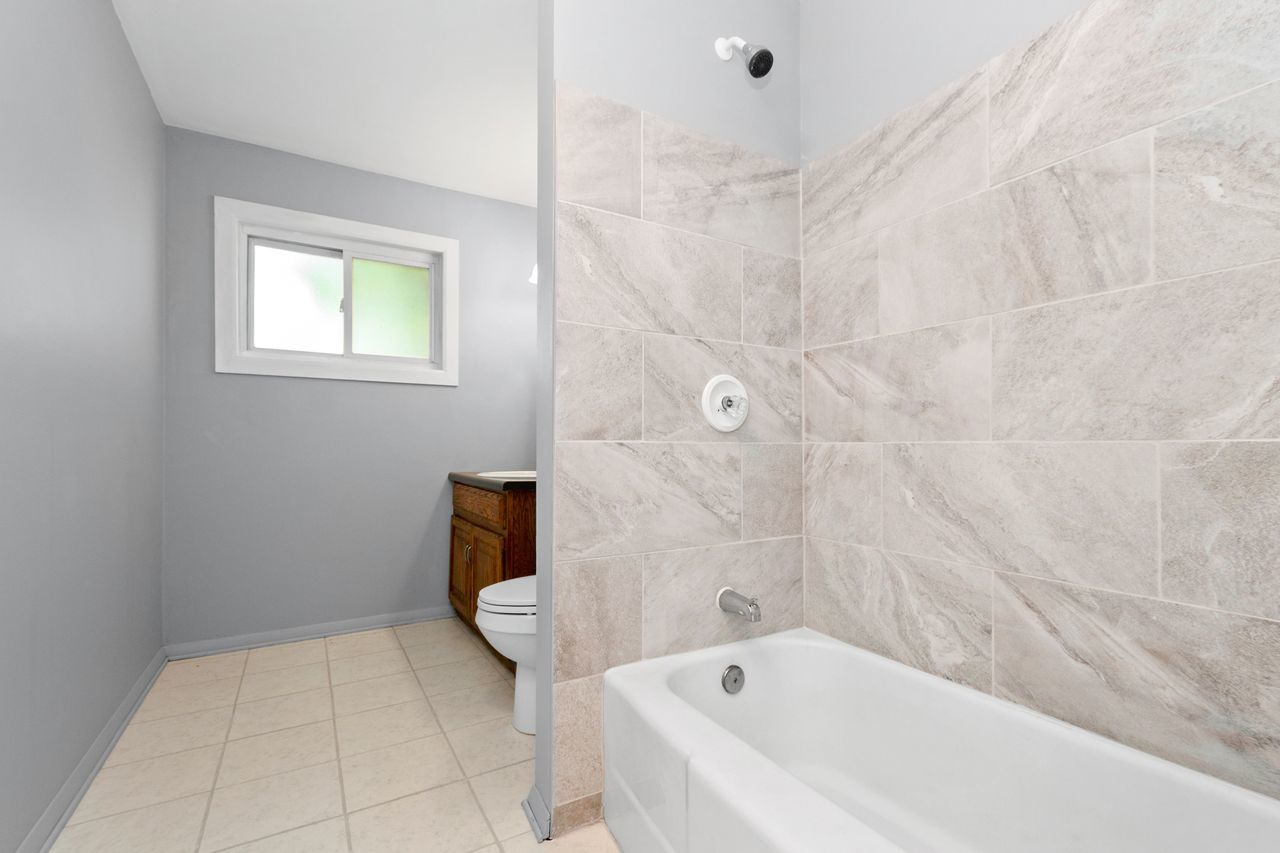 300 Indiana Street Park Forest, IL 60466 - Photo 22 of 26 a bathroom with a bathtub and toilet