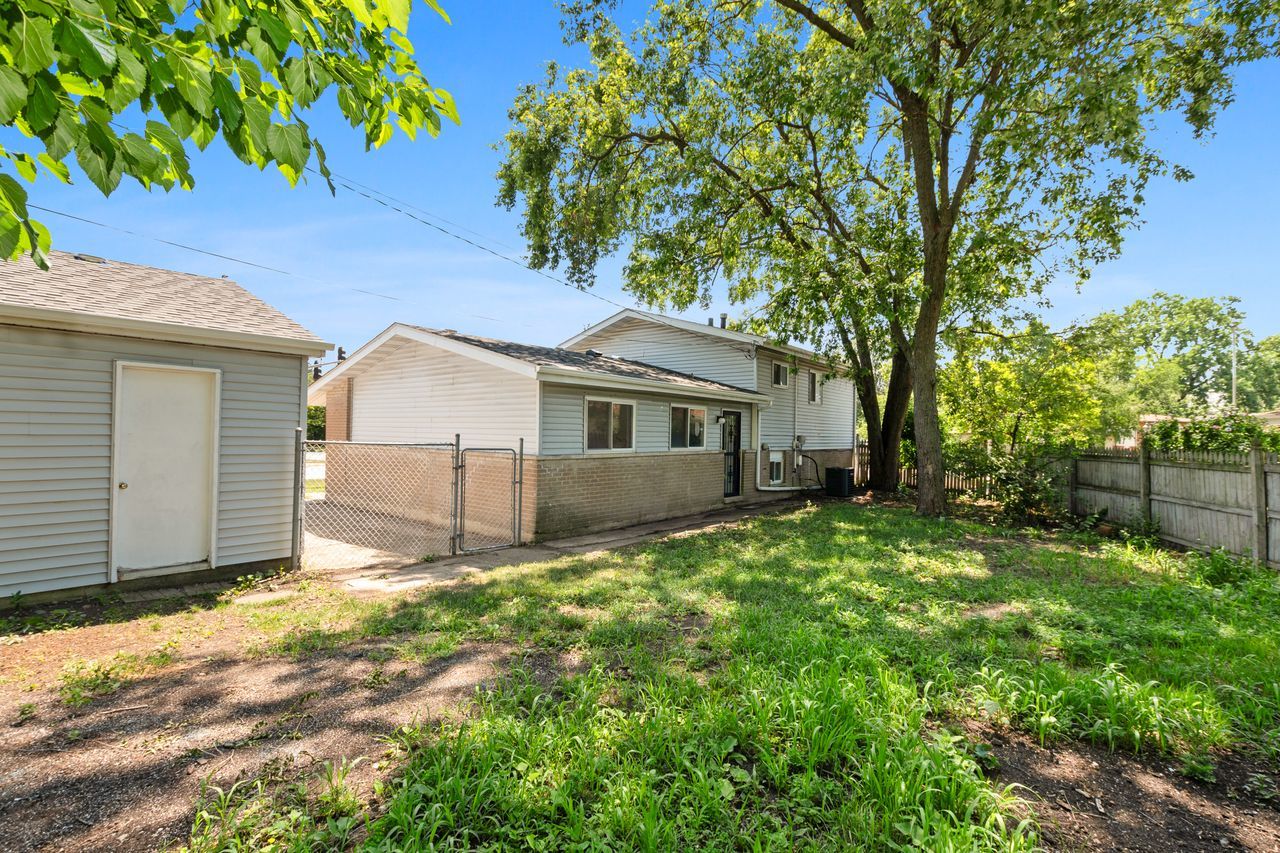 300 Indiana Street Park Forest, IL 60466 - Photo 25 of 26 a front view of a house with a garden and yard