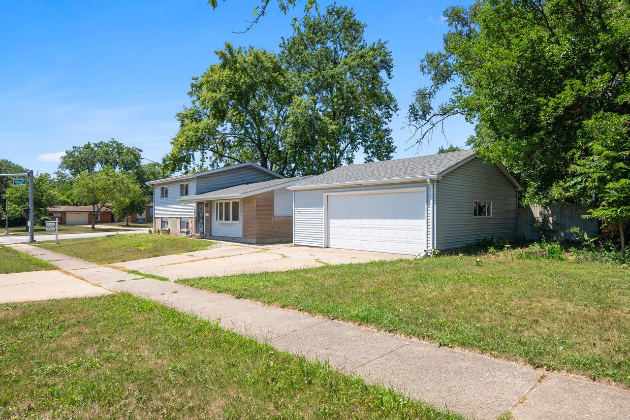300 Indiana Street Park Forest, IL 60466 - Photo 5 of 26 a view of a house with a backyard and a tree