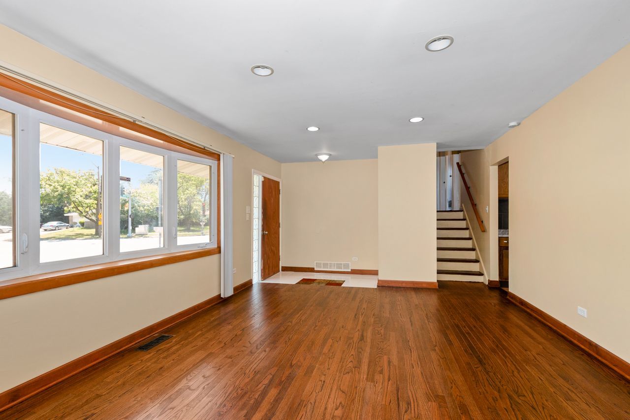 300 Indiana Street Park Forest, IL 60466 - Photo 6 of 26 a view of empty room with wooden floor and window