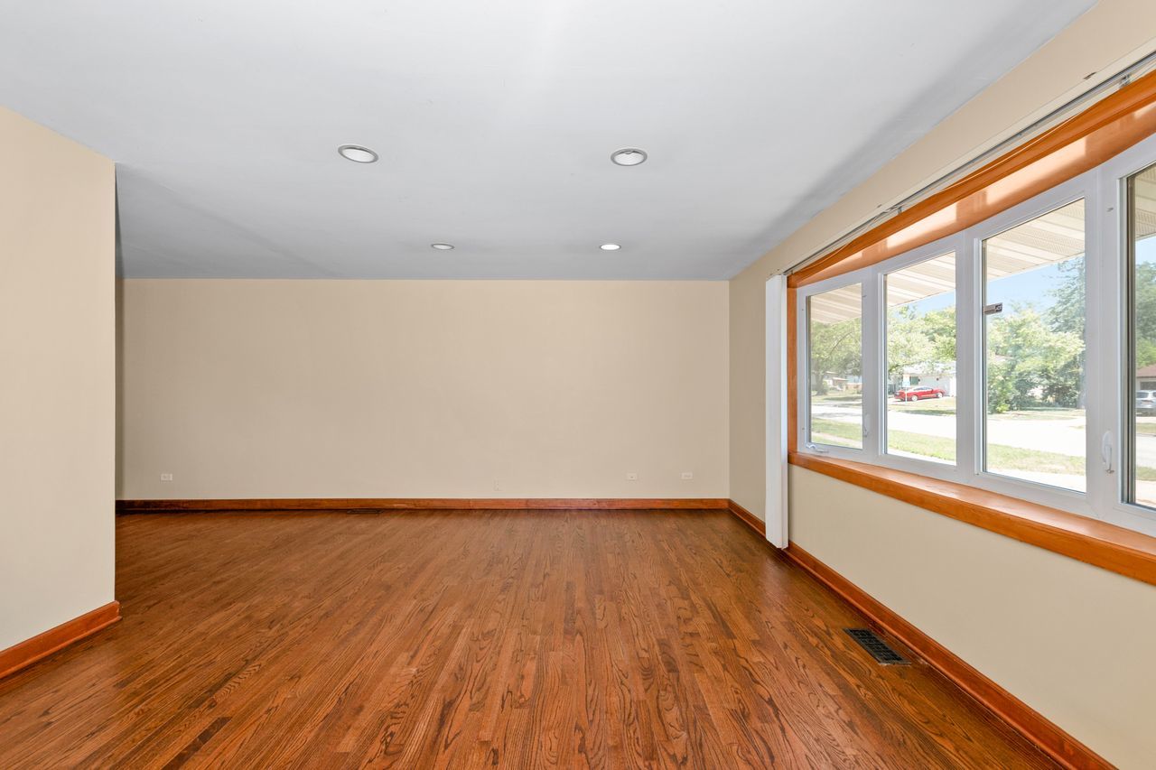 300 Indiana Street Park Forest, IL 60466 - Photo 7 of 26 a view of an empty room with wooden floor and a window