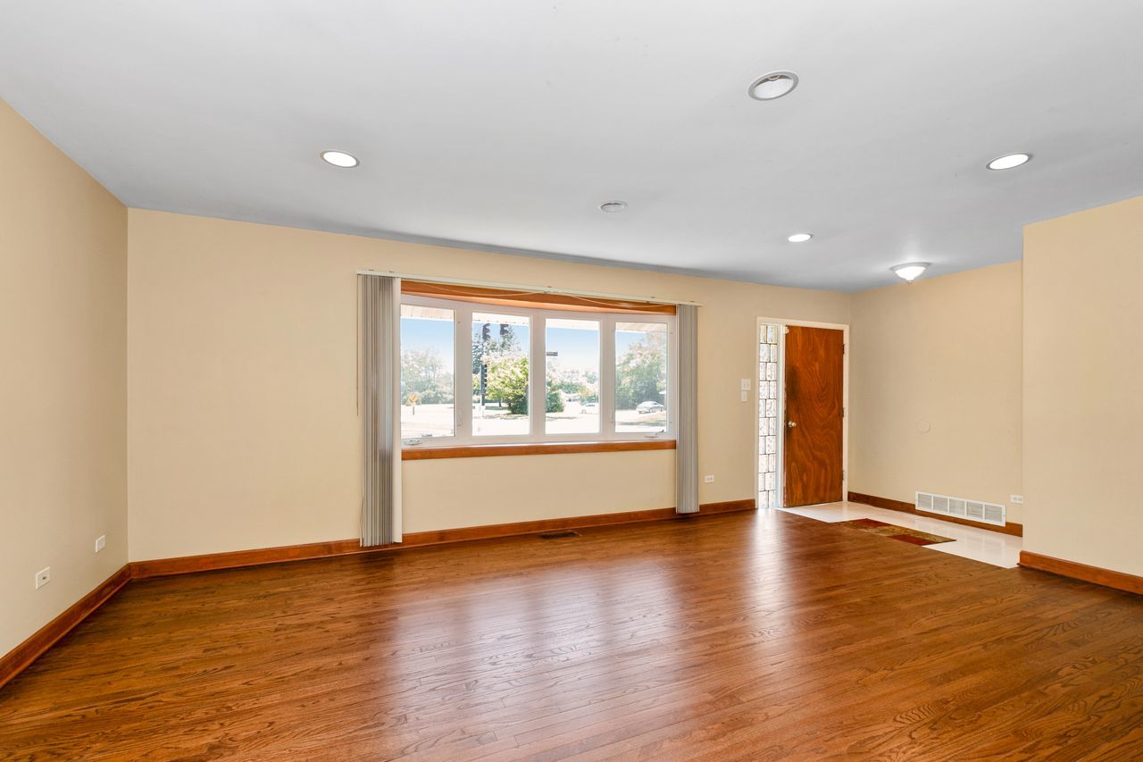 300 Indiana Street Park Forest, IL 60466 - Photo 8 of 26 a view of an empty room with wooden floor and a window