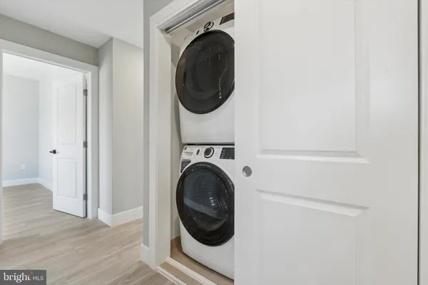 a close view of a utility room with dryer and washer