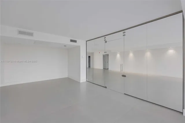 an empty room with windows and view