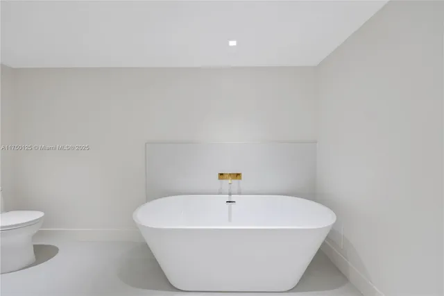 a view of a big room with wooden floor and windows