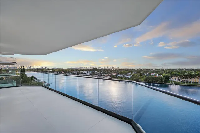 a view of a swimming pool with a yard and sitting space