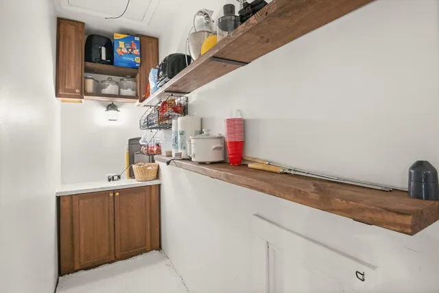 a kitchen with a sink and wooden cabinets