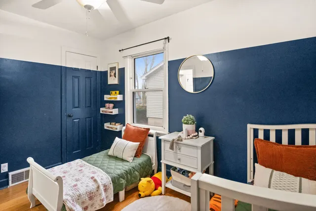 a bedroom with bed and a chair