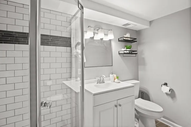 a bathroom with a sink toilet and shower