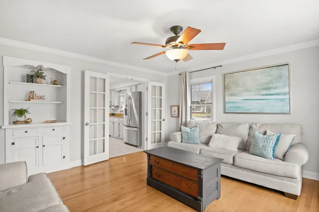 a living room with furniture and wooden floor