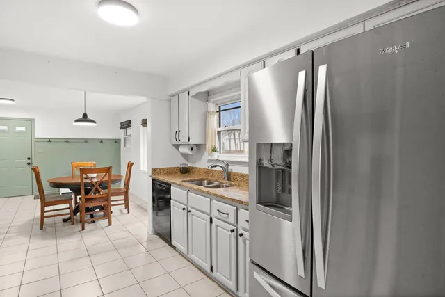 a kitchen with stainless steel appliances granite countertop a refrigerator and a stove top oven