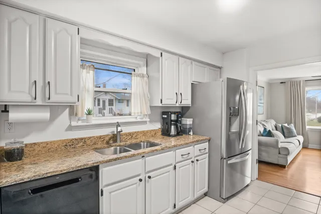 a kitchen with stainless steel appliances granite countertop a refrigerator sink and cabinets