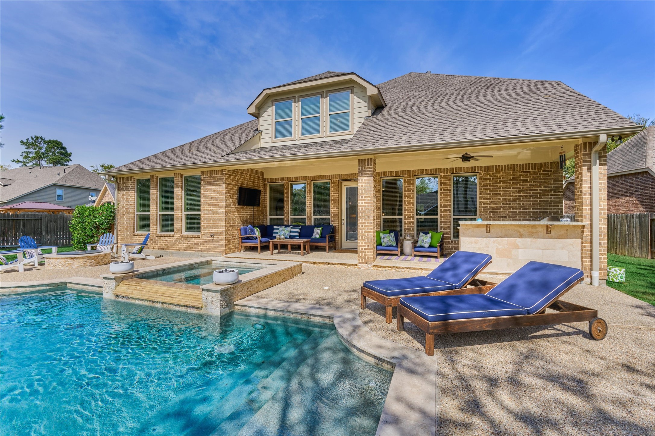 128 Shane Street Montgomery, TX 77316 - Photo 2 of 50 Have it all in this resort-like setting with sparkling pool & spa with upgraded pool surface, sheer descents, built-in fire pit, summer kitchen under a generous lanai.