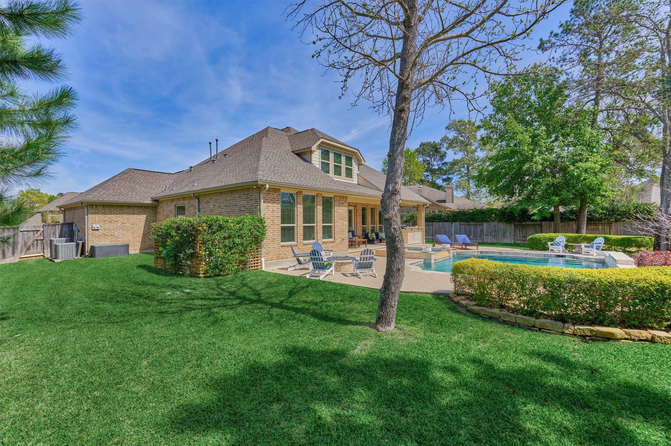 128 Shane Street Montgomery, TX 77316 - Photo 38 of 50 Yard & pool - a rare find! Almost looks like green carpet with immaculate manicuring, including an aesthetic trellis fence @ pool equipment.