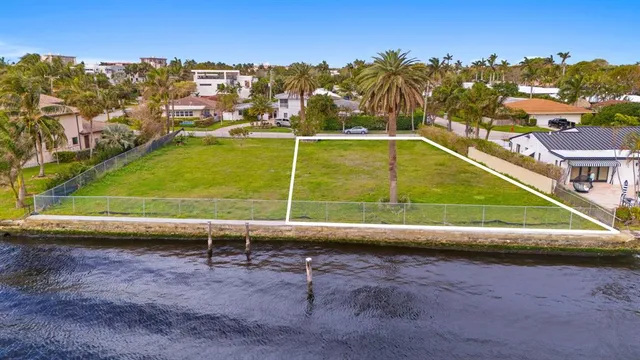 a view of a tennis ground with a large pool in the back