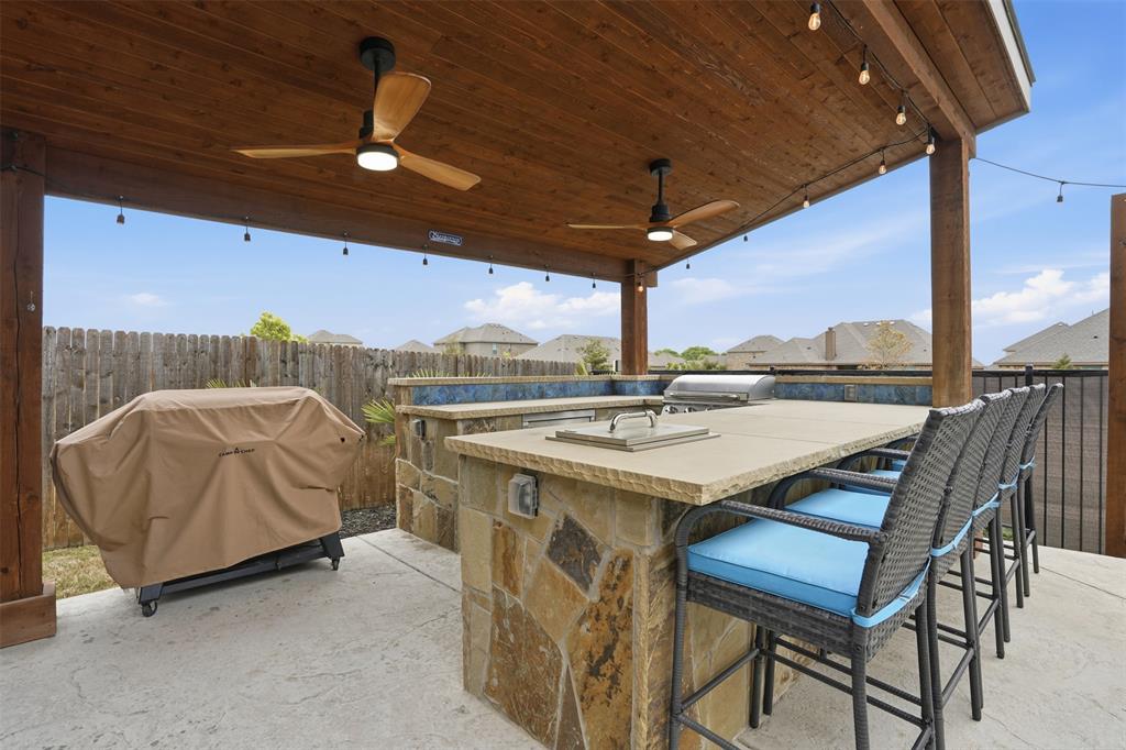 4002 Grove Valley Road Midlothian, TX 76065 - Photo 37 of 40 a view of a patio with a table and chairs under an umbrella