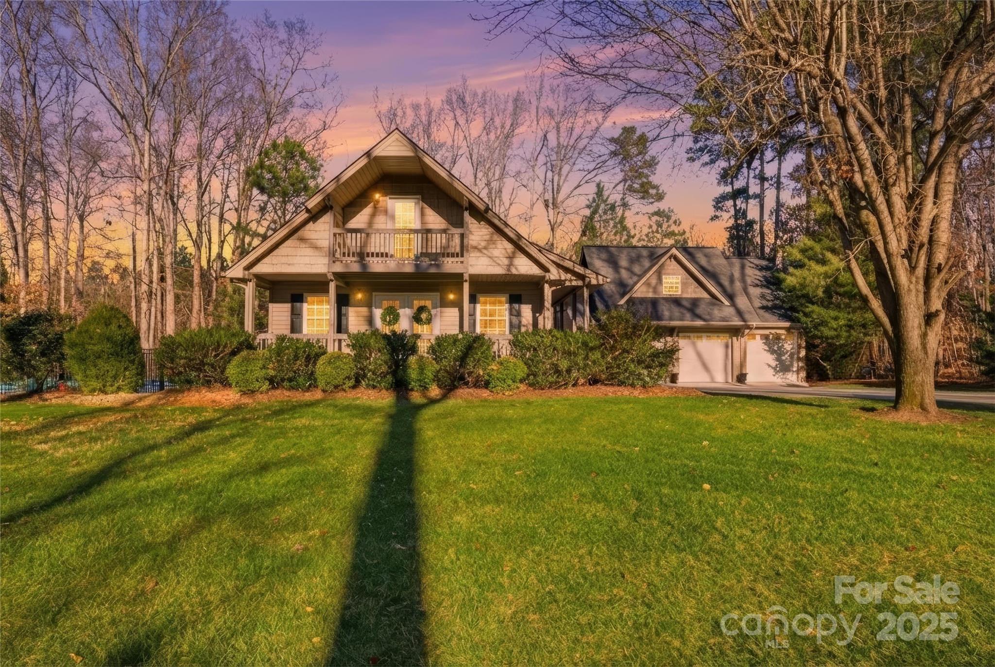 a front view of a house with yard and green space