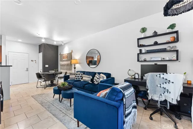 a living room with furniture and a mirror