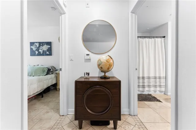 a vase of flowers sitting on a table with a potted plant