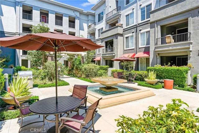 a large white kitchen with stainless steel appliances granite countertop a large counter top and a stove