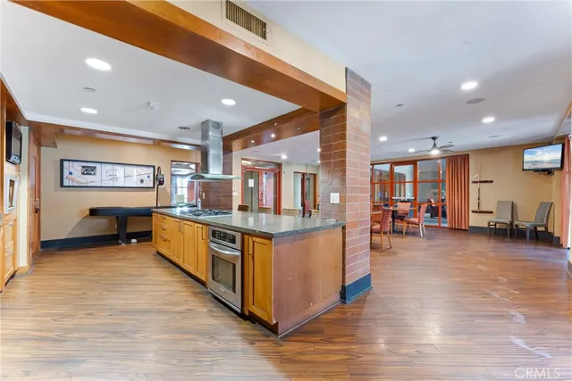 a view of a kitchen with wooden floor and a sink