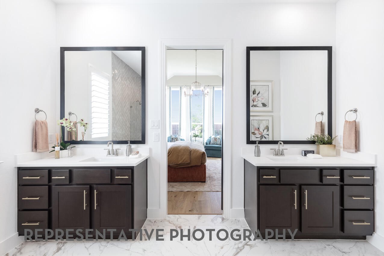 18918 Moonriver Street Conroe, TX 77302 - Photo 11 of 25 a en suite bathroom with a double vanity sink a mirror and a bathtub