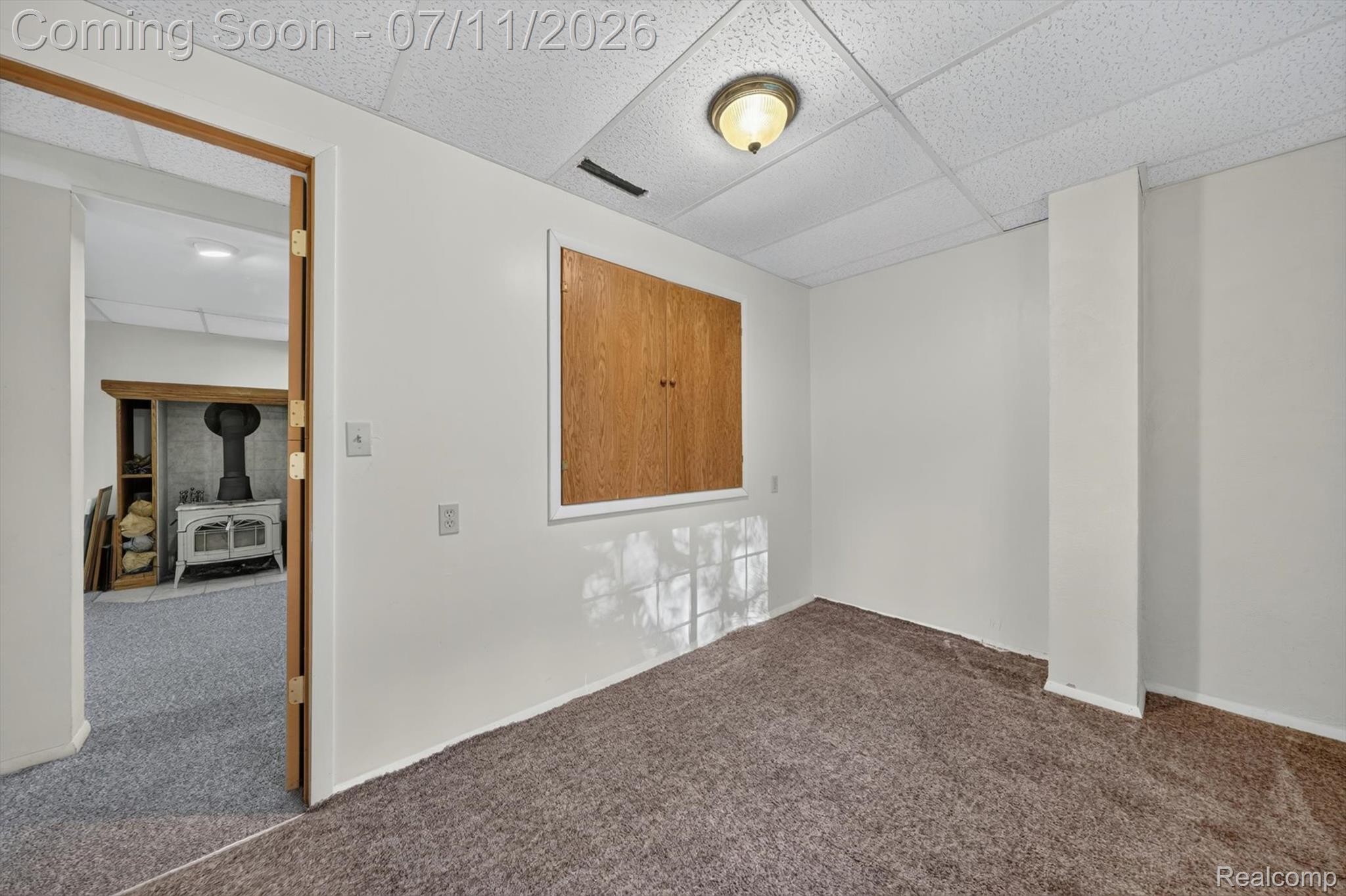 4430 North Center Road Flint, MI 48506 - Photo 37 of 49 Carpeted interior space with a dropped ceiling and flush-mounted light fixture