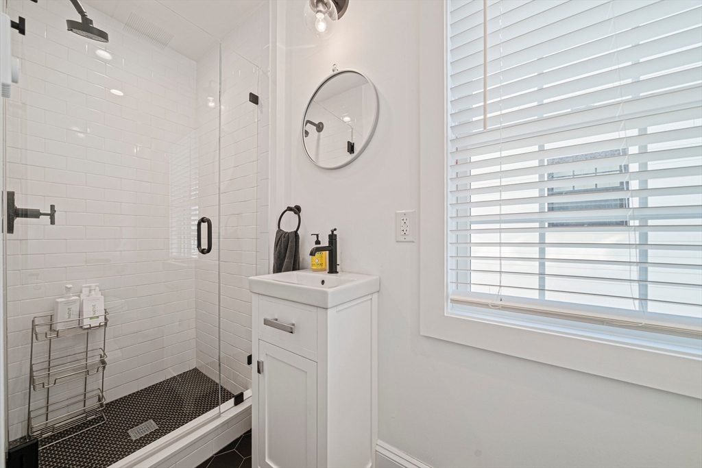 85 Glades Road Scituate, MA 02066 - Photo 15 of 42 a bathroom with a sink a mirror and a window