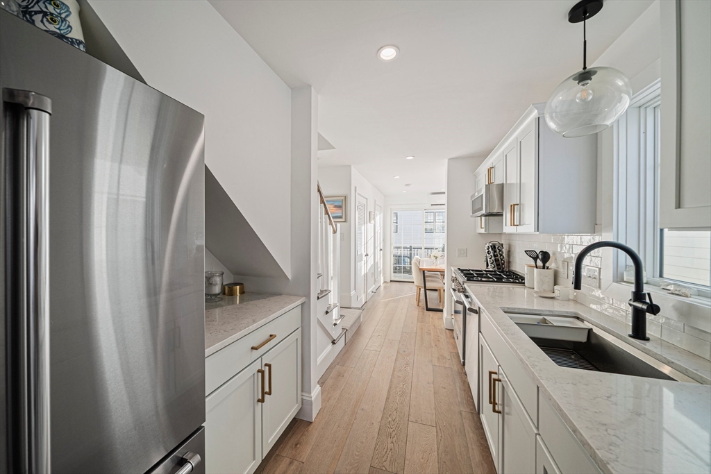 85 Glades Road Scituate, MA 02066 - Photo 6 of 42 a kitchen with stainless steel appliances a sink stove and refrigerator