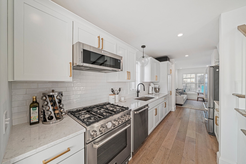 85 Glades Road Scituate, MA 02066 - Photo 7 of 42 a kitchen with stainless steel appliances a sink a stove top oven a counter space and cabinets