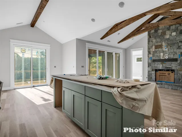 a kitchen with stainless steel appliances granite countertop a sink stove and wooden cabinets