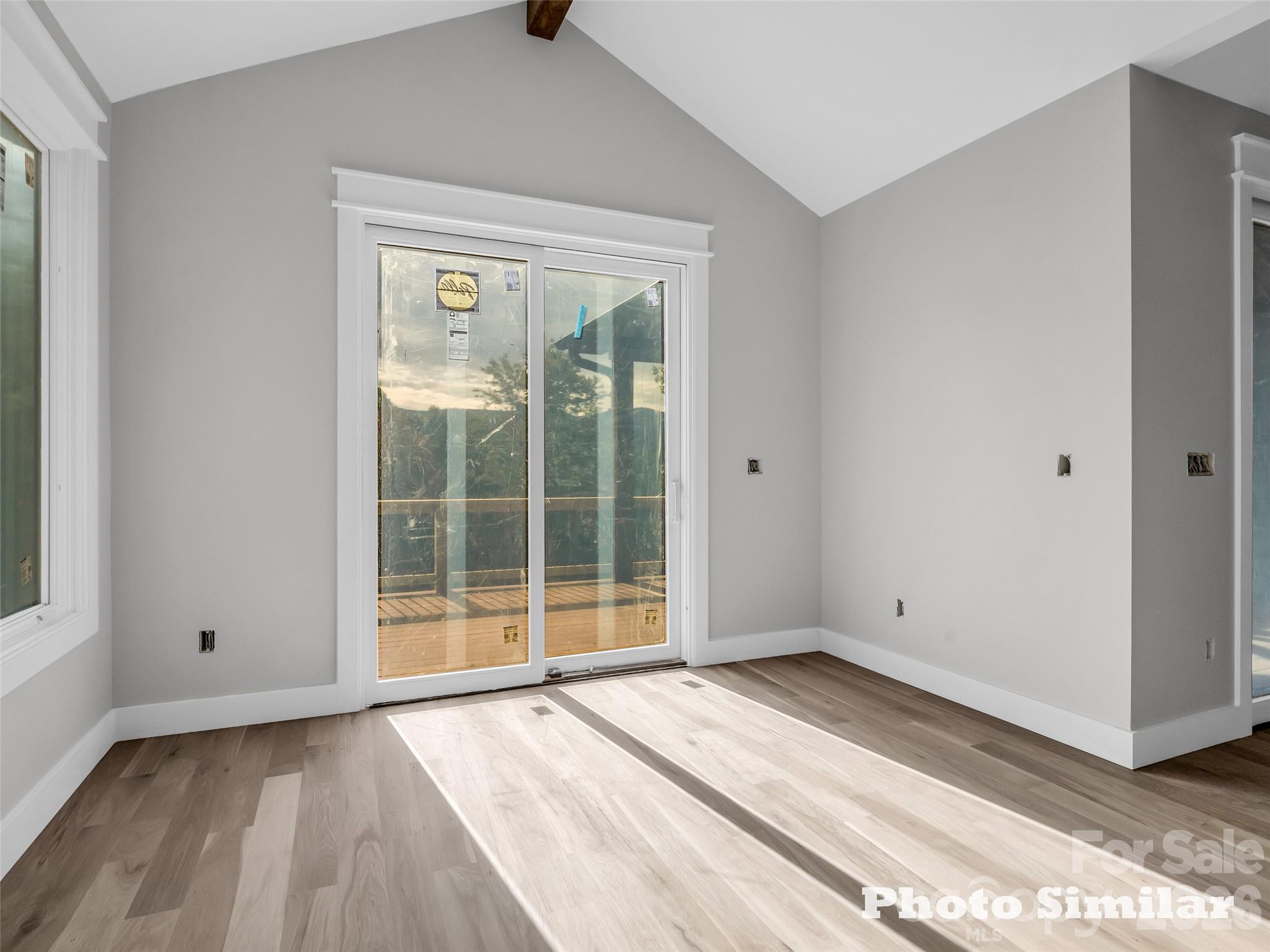 1 Jackson Ridge Ln Mill Spring Mill Spring, NC 28756 - Photo 15 of 43 a view of an empty room with wooden floor and a window